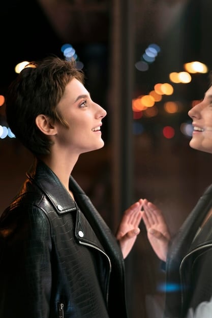 A mid-shot of two main characters in a K-drama confronting each other in a dimly lit room. One character looks down guiltily, while the other stares with intense anger and disappointment. Rain is visible through the window in the background, enhancing the dramatic atmosphere.