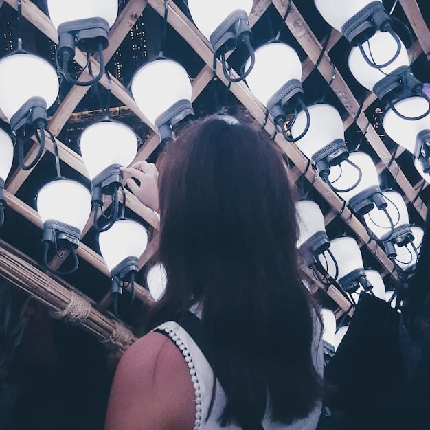 A behind-the-scenes photograph of a dorama set in Seoul, capturing the complex lighting setup, multiple cameras, and the director instructing the actors, highlighting the high production values and attention to detail.