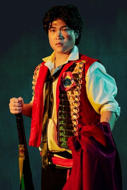 A still from a historical K-drama, showcasing actors in traditional Korean attire, set against a backdrop of ancient palaces and landscapes. The scene should convey a sense of grandeur and historical authenticity.
