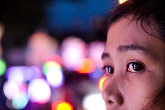 A close-up of a person's eyes focused intently on a screen displaying Korean subtitles over a vibrant dorama scene. Soft, focused lighting highlights the concentration.